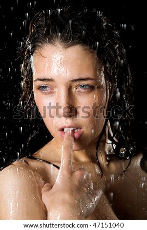 Young girl portrait in rain isolated on black background