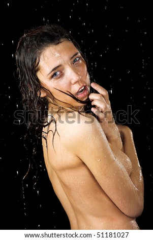 stock photo Young nude girl in rain isolated on black background
