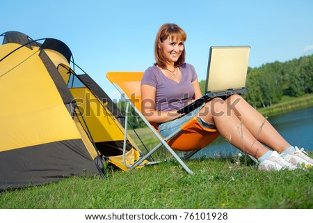 young beauty woman with laptop near the tent