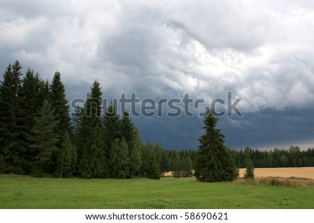 Storm clouds approaching countryside