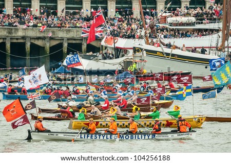 LONDON, UK - JUNE 3:  Colorful flotilla of rowing boats, part of the Queen Elizabeth II Diamond Jubilee Pageant on the River Thames, London, UK on June 3, 2012