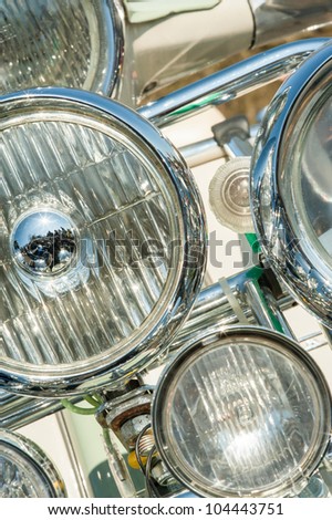 multiple headlight assembly on a 1960\'s retro Italian motorcycle scooter