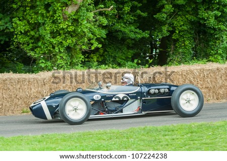 GOODWOOD, UK - JULY 1: Motor-sport legend, Stirling Moss in his classic Lotus 18 Formula 1 car on the hill course at Goodwood, UK on July 1, 2012