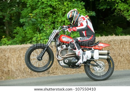GOODWOOD, UK - JULY 1: World Superbike Champion James Toseland pulling a wheelie on a classic Harley Davidson XR750 motorcycle on the hill course at Goodwood, UK on July 1, 2012