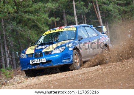 BRAMSHILL FOREST, UK - NOVEMBER 3, 2012: Driver Wug Utting kicking up dust in a Subaru Impreza on the Warren stage of the MSA Tempest Rally in Bramshill Forest, UK on November 3, 2012