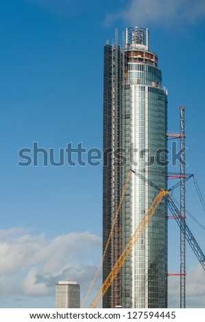 LONDON, UK -JANUARY 27: Repairs being made to the construction crane on The Tower, recently hit by a helicopter at St George Wharf, London, UK on January 27, 2013