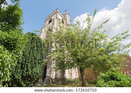 Lush vegetation surrounding All Saints parish church in Wokingham, Berkshire, UK