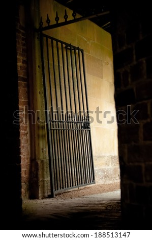 iron gate exit from a dark mysterious alleyway