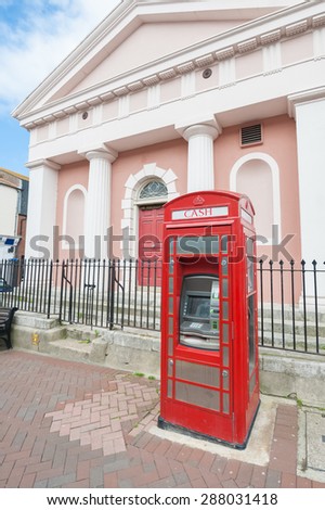WEYMOUTH, UK - JUNE 13: Vintage red telephone box converted into a ATM cash machine in Weymouth, UK - June 13, 2013