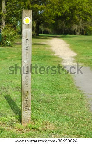 public foot path direction sign into woodland