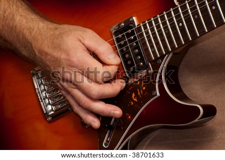 closeup of guitarists hand during a live performance