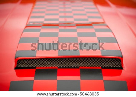 red and black checked pattern on a vehicle hood