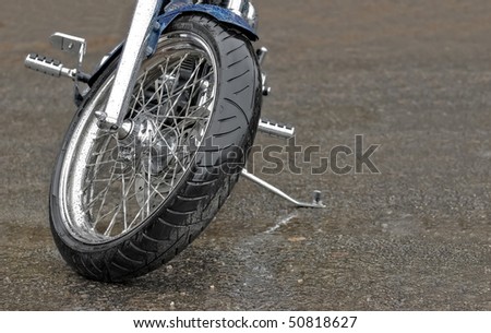 large motorcycle leaning on its stand in the rain
