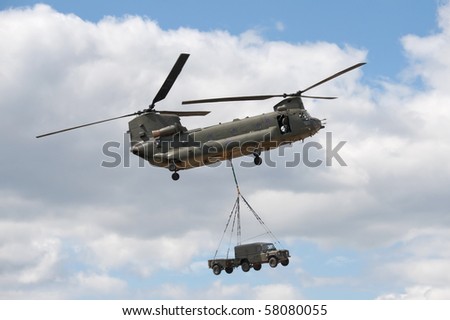 FARNBOROUGH, UK - JULY 24: RAF Chinook helicopter in vehicle lift demonstration. July 24 2010, Farnborough Airshow, UK