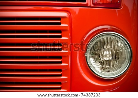 red truck grill and headlight with focus only on the light