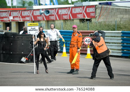 THRUXTON, UNITED KINGDOM - MAY 1: Attractive grid girl being photographed by the media at the British Touring Car Championships on May 1, 2011 at Thruxton, UK