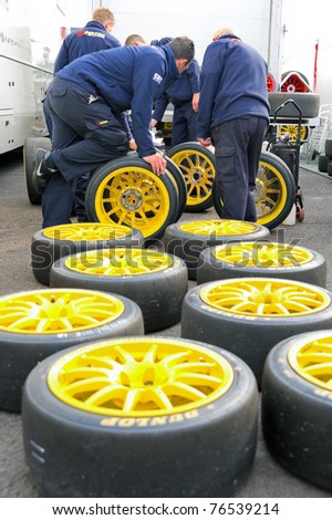 THRUXTON, UNITED KINGDOM - MAY 1: Pirtek pit crew making tire choices before racing in the British Touring Car Championships. May 1, 2011. Thruxton, UK