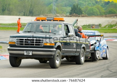 THRUXTON, UNITED KINGDOM - MAY 1: Recovery truck tows away the wreckage of the Chevrolet Cruze driven by Jason Plato during the BTCC meeting on May 1, 2011 in Thruxton, UK.