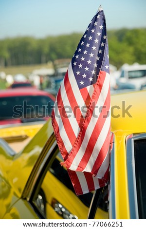USA stars and stripes flag flown from a car window