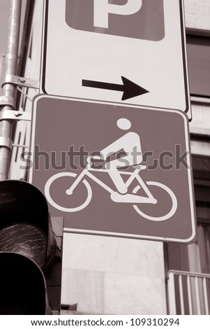 Urban bicycle sign with red traffic light