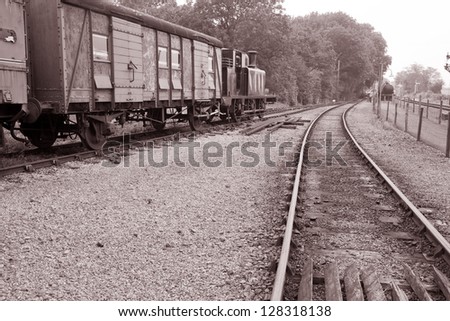 Vintage Railway Engine and Goods Wagon on Track in Black and White Sepia Tone