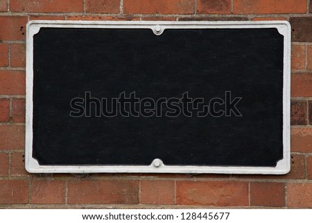 Empty Blank Black Sign on Brick Stone Wall