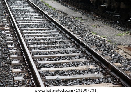 Railway Track and Platform and Train in the Rain