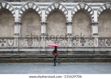 Exterior Facade of Santa Maria Novella Church; Florence; Italy with Woman Walking with Umbrella