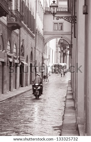 Lungarno degli Acciaiuoli Street in Florence with Motorbike Scooter, Italy in Black and White Sepia Tone