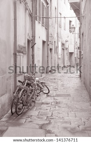 Disused Bikes in the Streets of Pisa, Italy in Black and White Sepia Tone