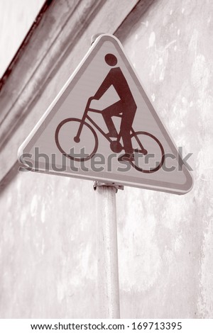 Yellow Cycling Sign in Urban Setting