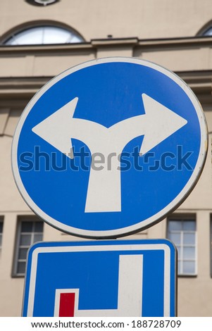 Blue Two Directions Traffic Sign in Urban Setting