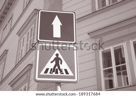 Pedestrian and One Way Sign in Urban Setting