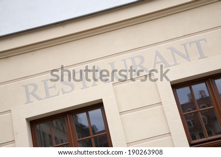 Silver Restaurant Sign on Wall Background on Diagonal Slant