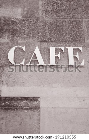 Cafe Sign on Stone Wall