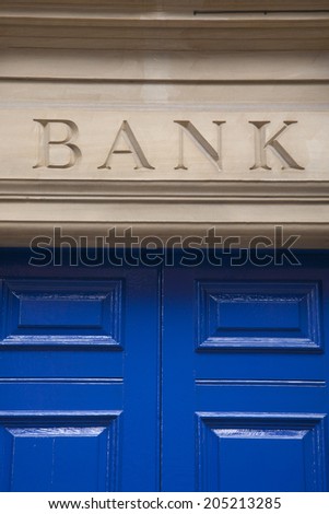 Close-up of Bank Sign on Yellow Stone Background