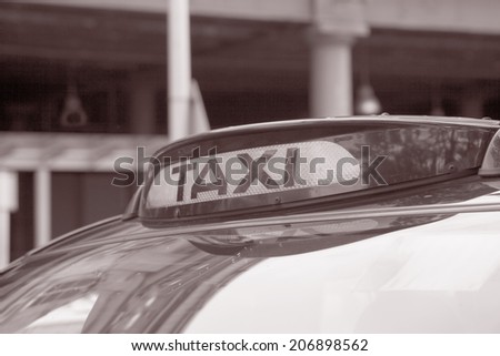 Closeup of Taxi Sign in Railroad Car park in Black and White Sepia Tone