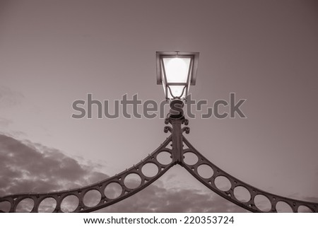 Illuminated Lamp on Ha\'Penny Bridge, Dublin, Ireland in Black and White Sepia Tone