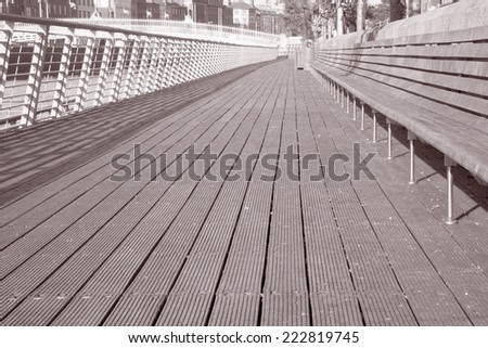 Sidewalk and Ha\'Penny Bridge, River Liffey; Dublin, Ireland in Black and White Sepia Tone