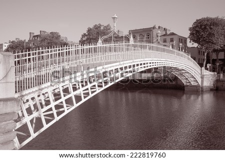 Ha\'Penny Bridge and the River Liffey, Dublin, Ireland in Black and White Sepia Tone