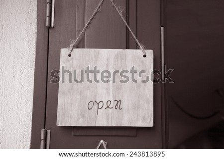 Open Sign on Shop Door Entrance in Black and White Sepia Tone