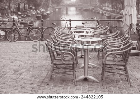 Cafe Table and Canal, Amsterdam, Holland, Netherlands in Black and White Sepia Tone