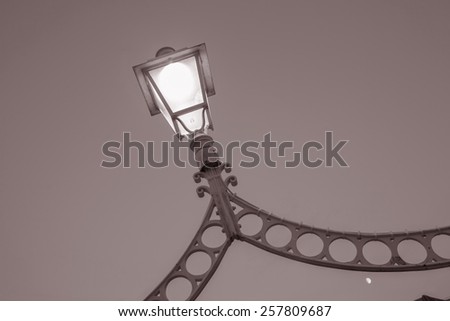Illuminated Lamp on Ha\'Penny Bridge, Dublin, Ireland in Black and White SepÃ?Â¬a Tone
