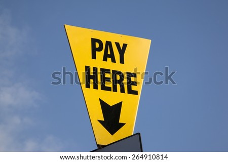 Yellow Pay Here Sign in Car Park