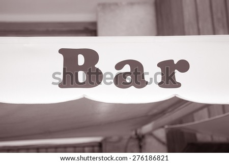 Bar Sign in Urban Setting in Black and White Sepia Tone
