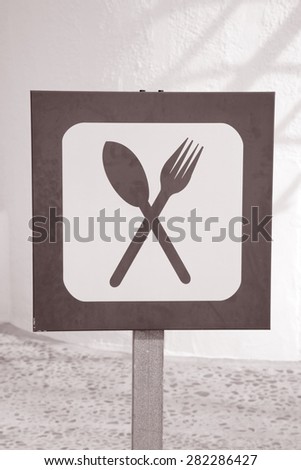 Food and Drink Sign against White Wall in Black and White Sepia Tone