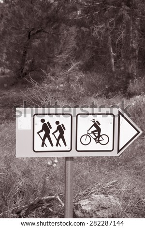 Bike and Walking Tour Sign in Nature Setting in Black and White Sepia Tone