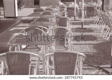 Cafe Table and Chairs in Outdoor Setting in Black and White Sepia Tone