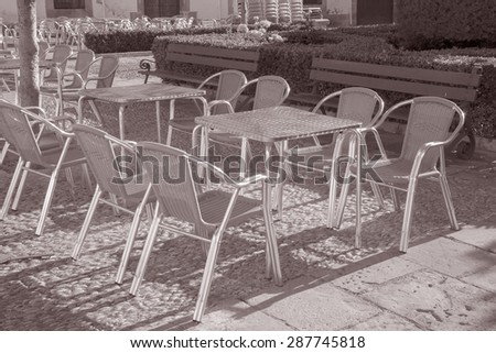 Cafe Table and Chairs in Outdoor Setting in Black and White Sepia Tone