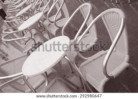 Cafe Tables and Chairs in St Marks Square, Venice, Italy in Black and White Sepia Tone